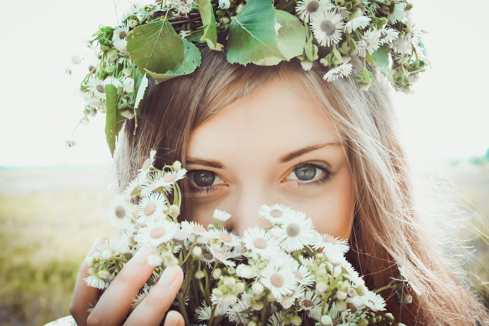Photo of a Woman with a Flower Crown Holding White Flowers